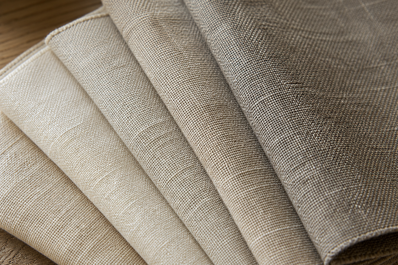 Linen upholstery fabric swatches in flax, oatmeal, natural, ivory, greige, and stone linen-look textures for sample-first texture, color, and yardage planning